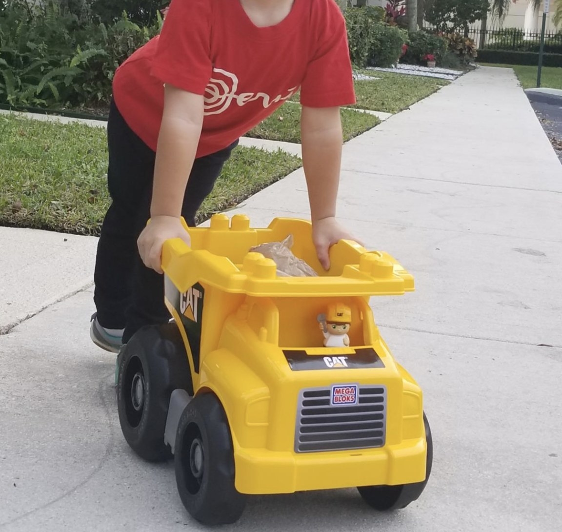 reviewer photo showing their child playing with the truck