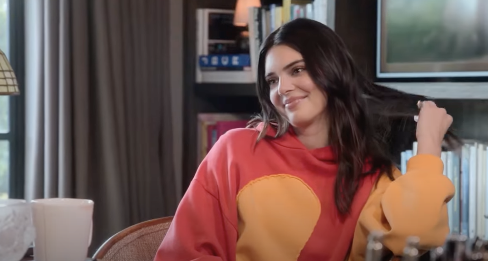 Kendall smiling and touching her hair