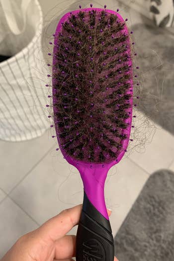 writer's hairbrush with lots of hair in it