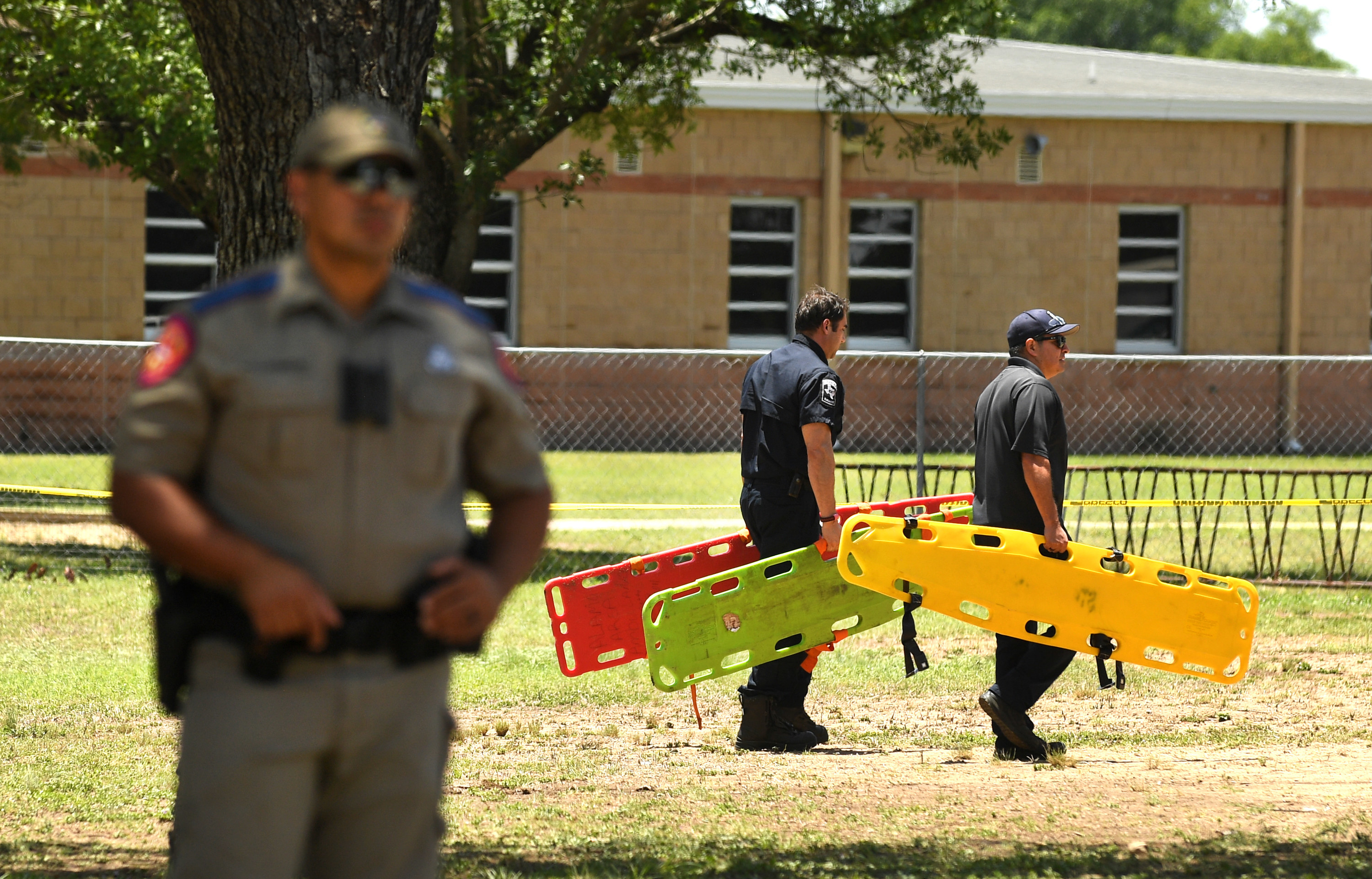 Emergency officials clean up outside Robb Elementary School in Uvalde, Texas Wednesday May 25, 2022.