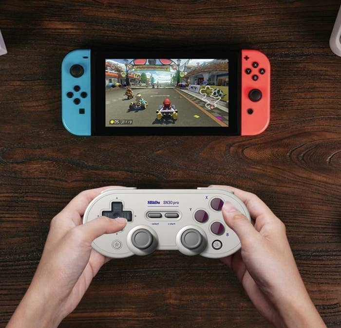 Someone using the controller to play a video game on a switch