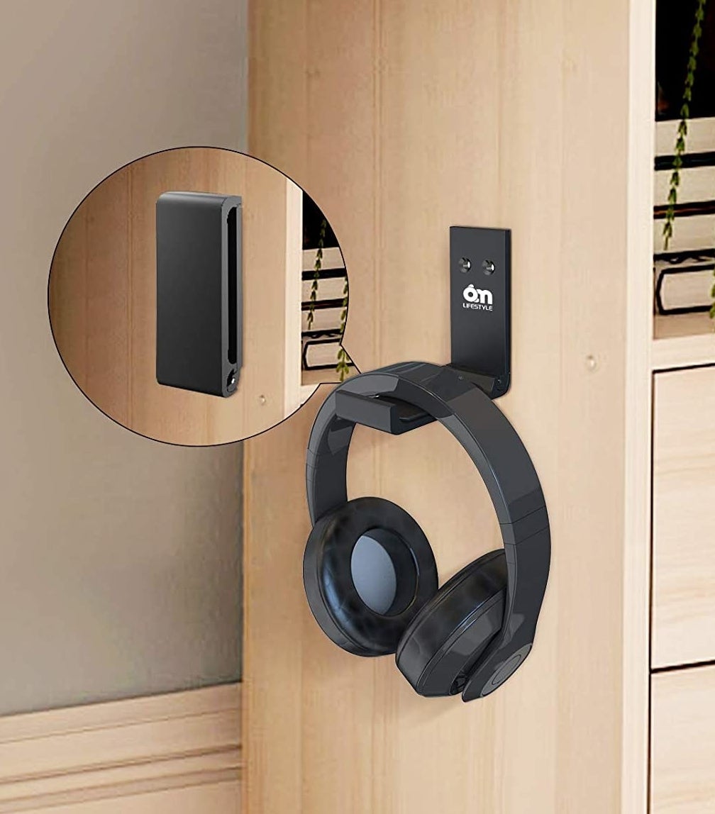a pair of headphones hung on the wall mounted holder
