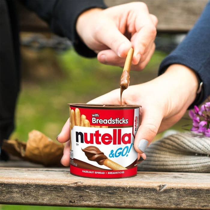 a pair of people sharing the nutella snack pack