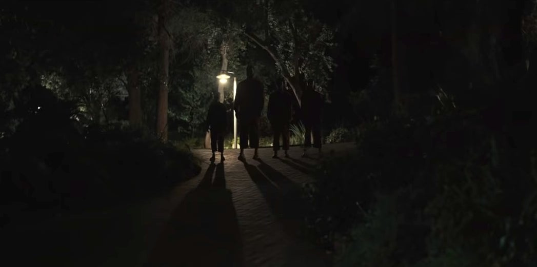 The Tethered versions of the Wilsons standing in their driveway in &quot;Us&quot;