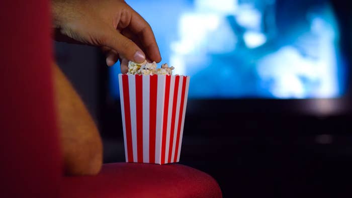 movie-goer eats popcorn
