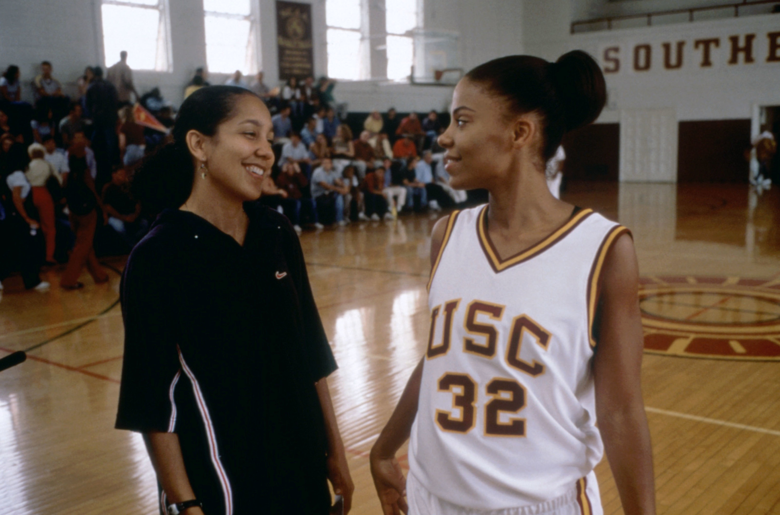 Sanaa with the director, Gina, on an indoor basketball court