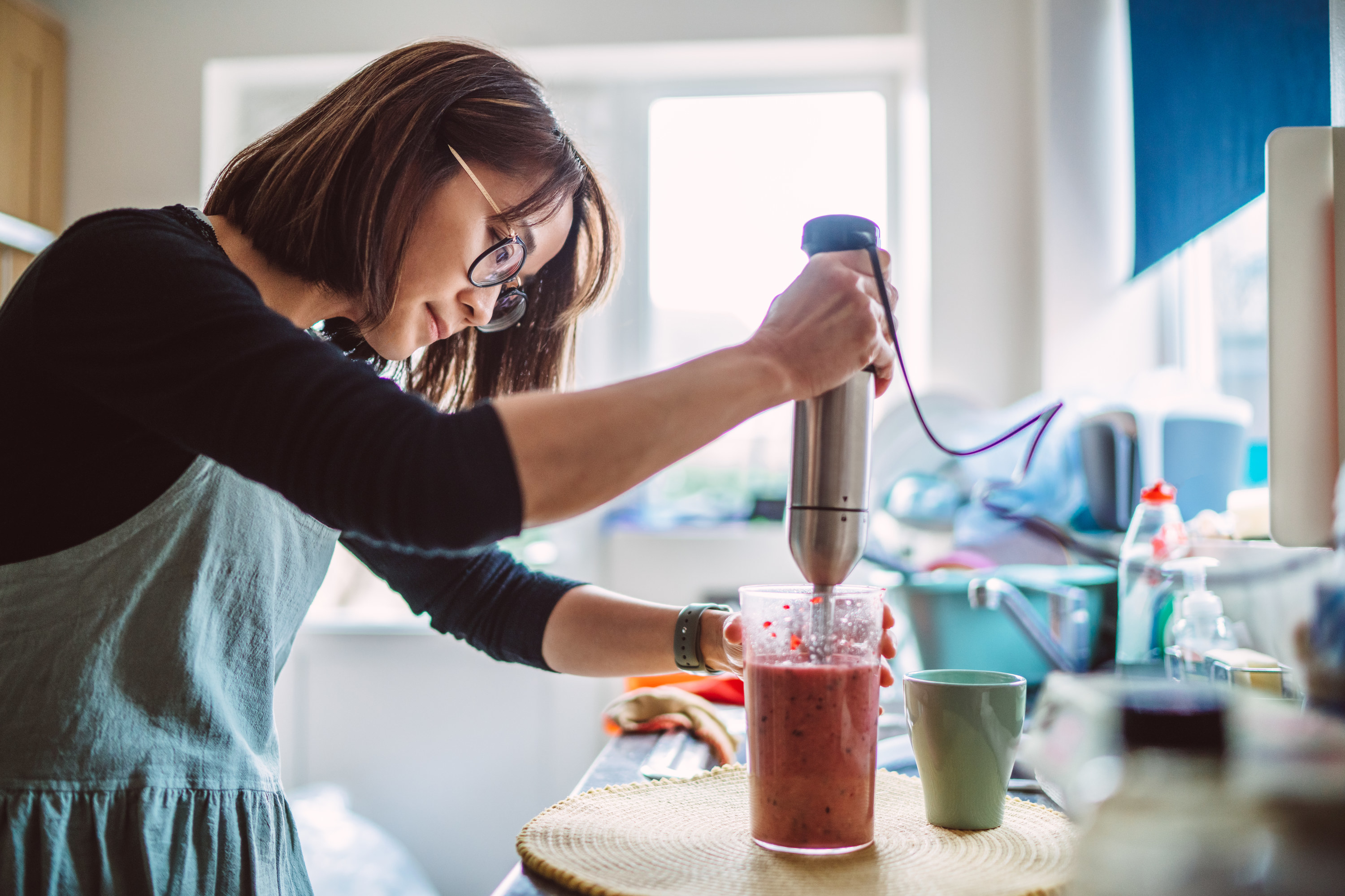 A woman mixing something in a kitchen