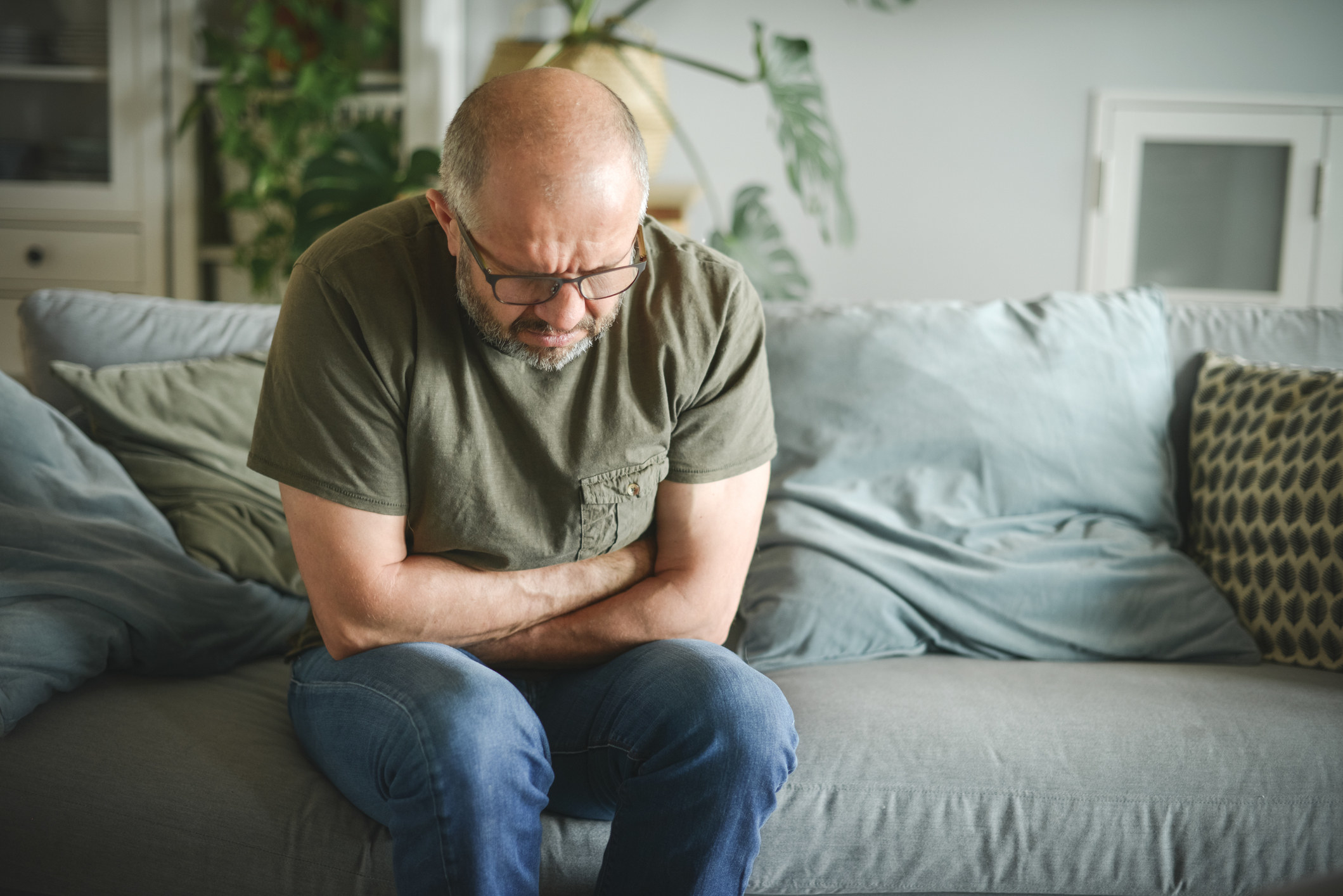 man clutching his stomach