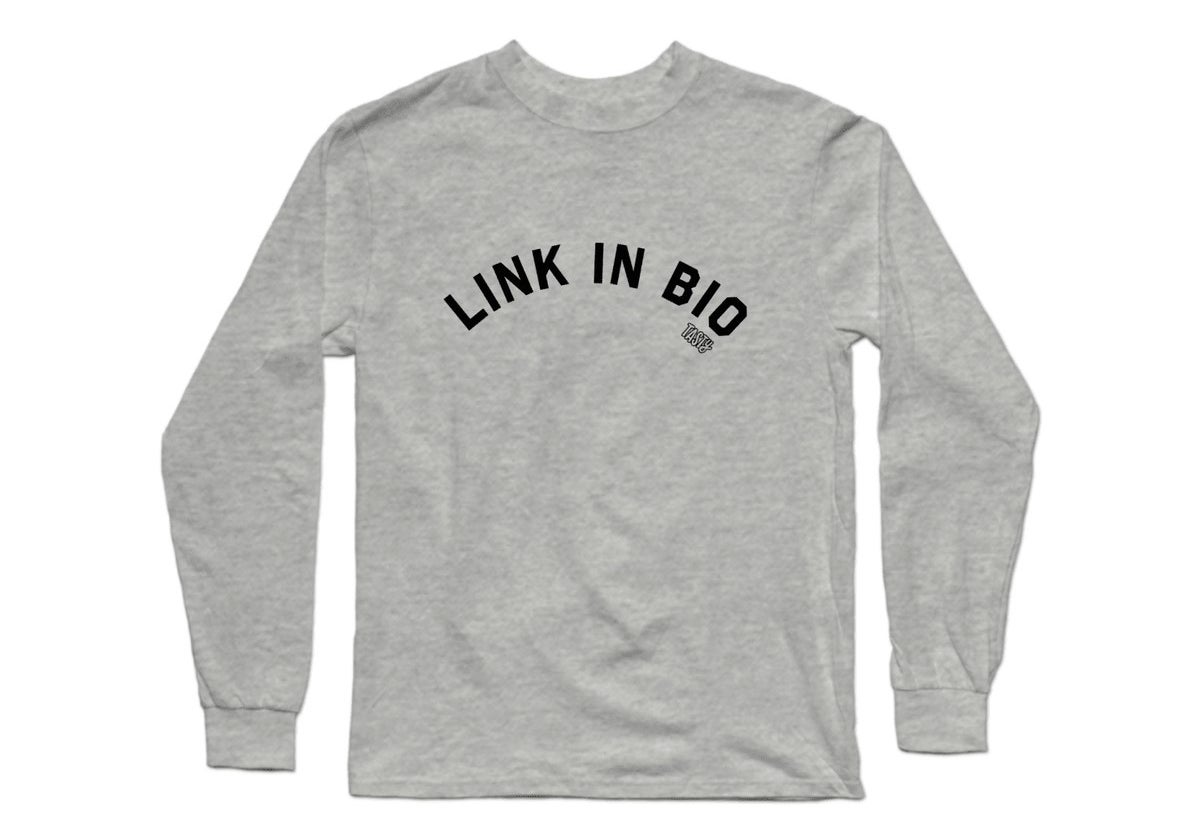 a grey long sleeved t-shirt with &quot;link in bio&quot; in black text