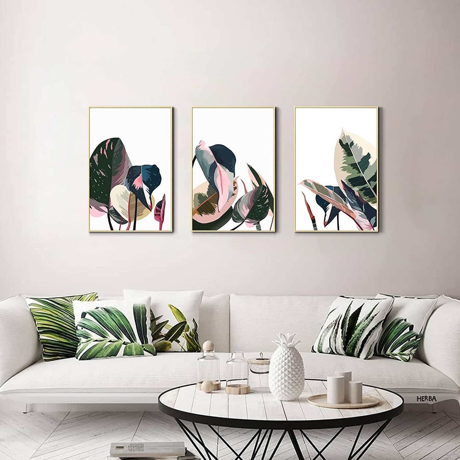 the three paintings hanging over a couch