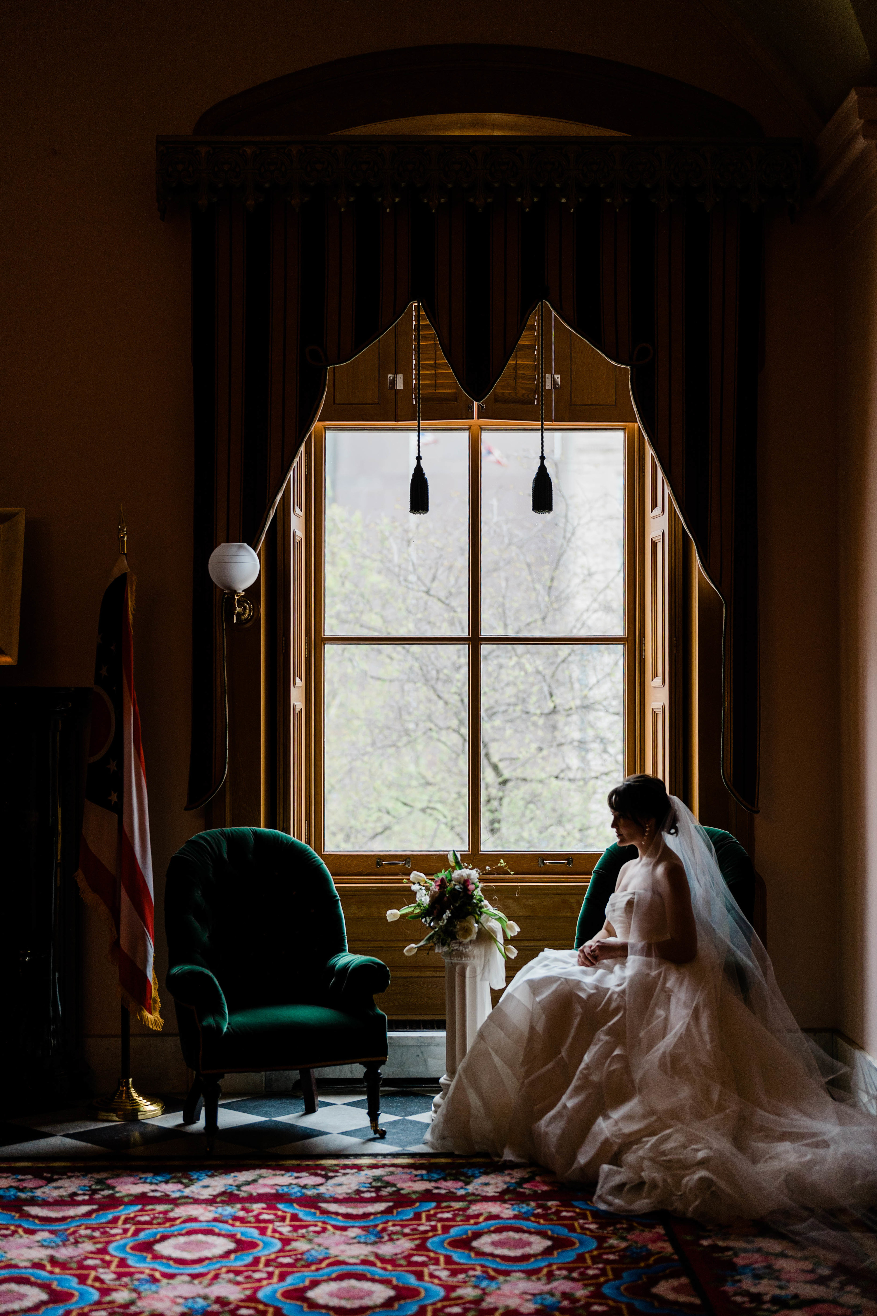 a woman sitting down with her wedding dress