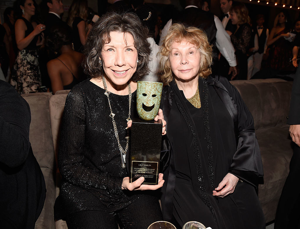 Lily holding an award and Jane smiling