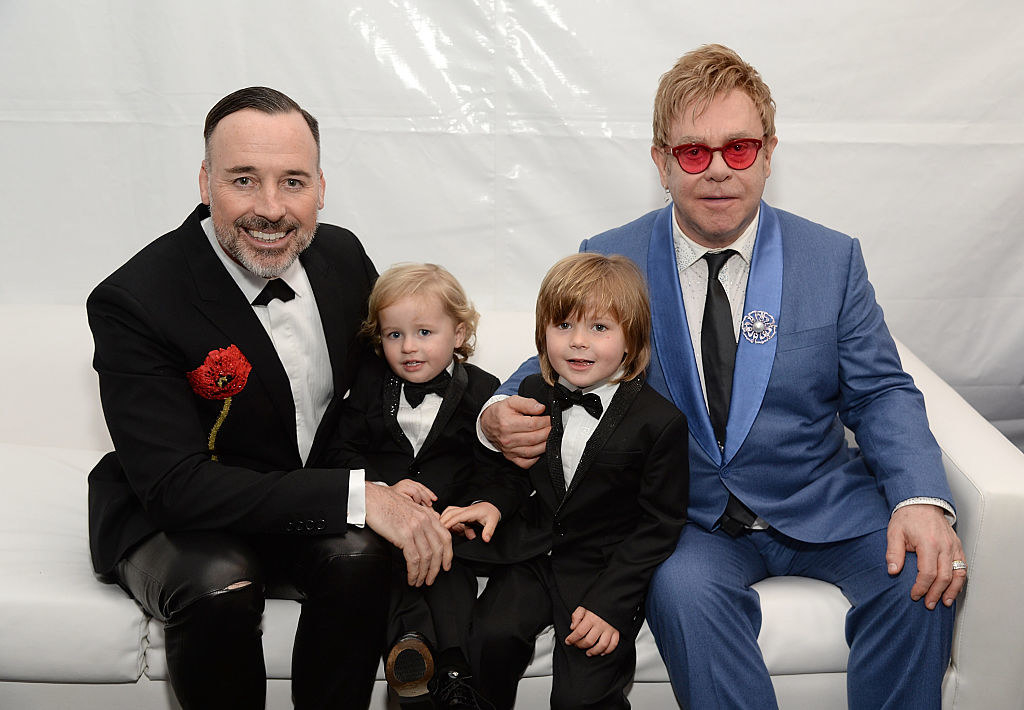 Elton and David smiling with their two kids