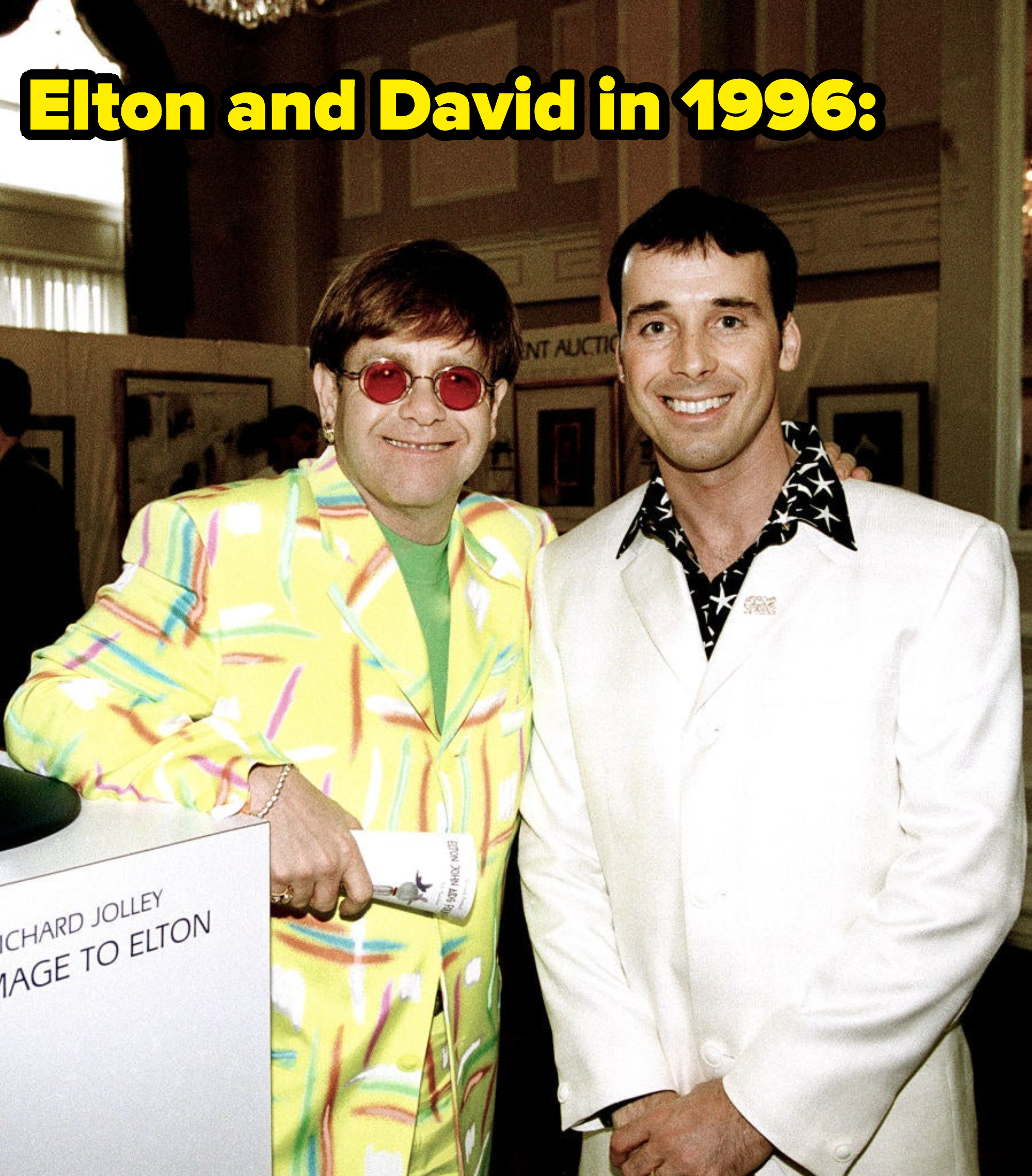 Elton and David smiling in a picture from 1996