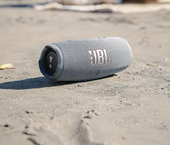 The speaker sitting on sand on the beach