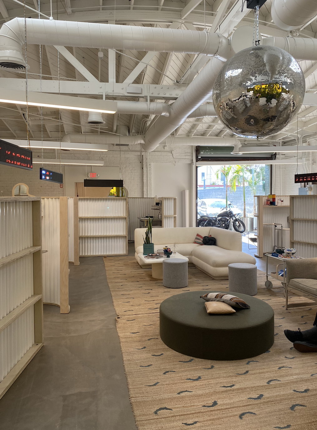 the clean and modern interior with large couches and large disco ball above