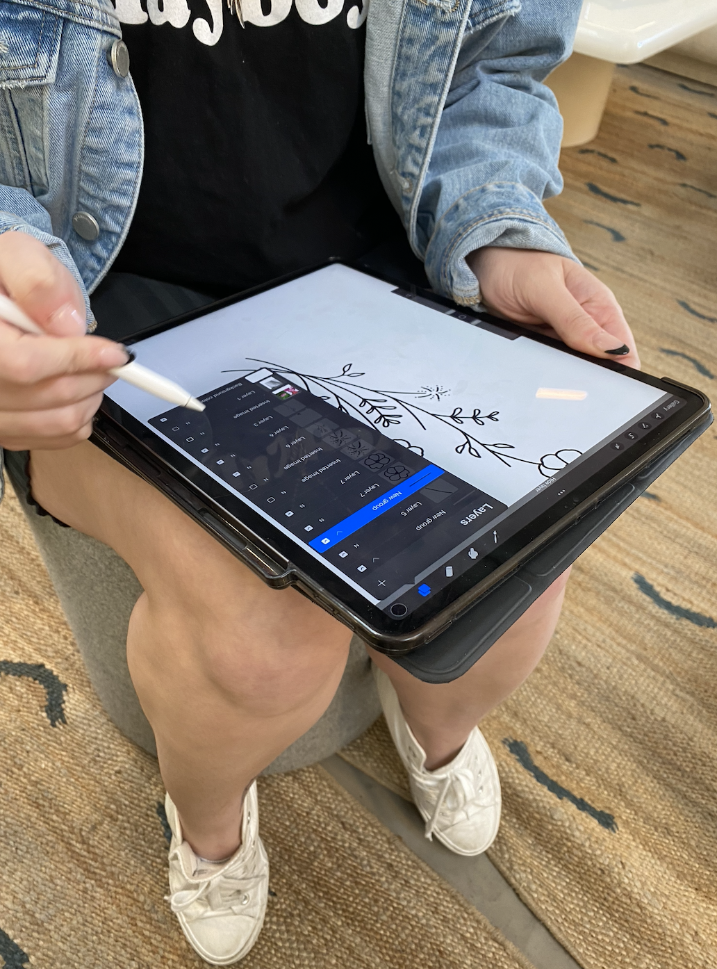 close up of the artist drawing out a design on a tablet