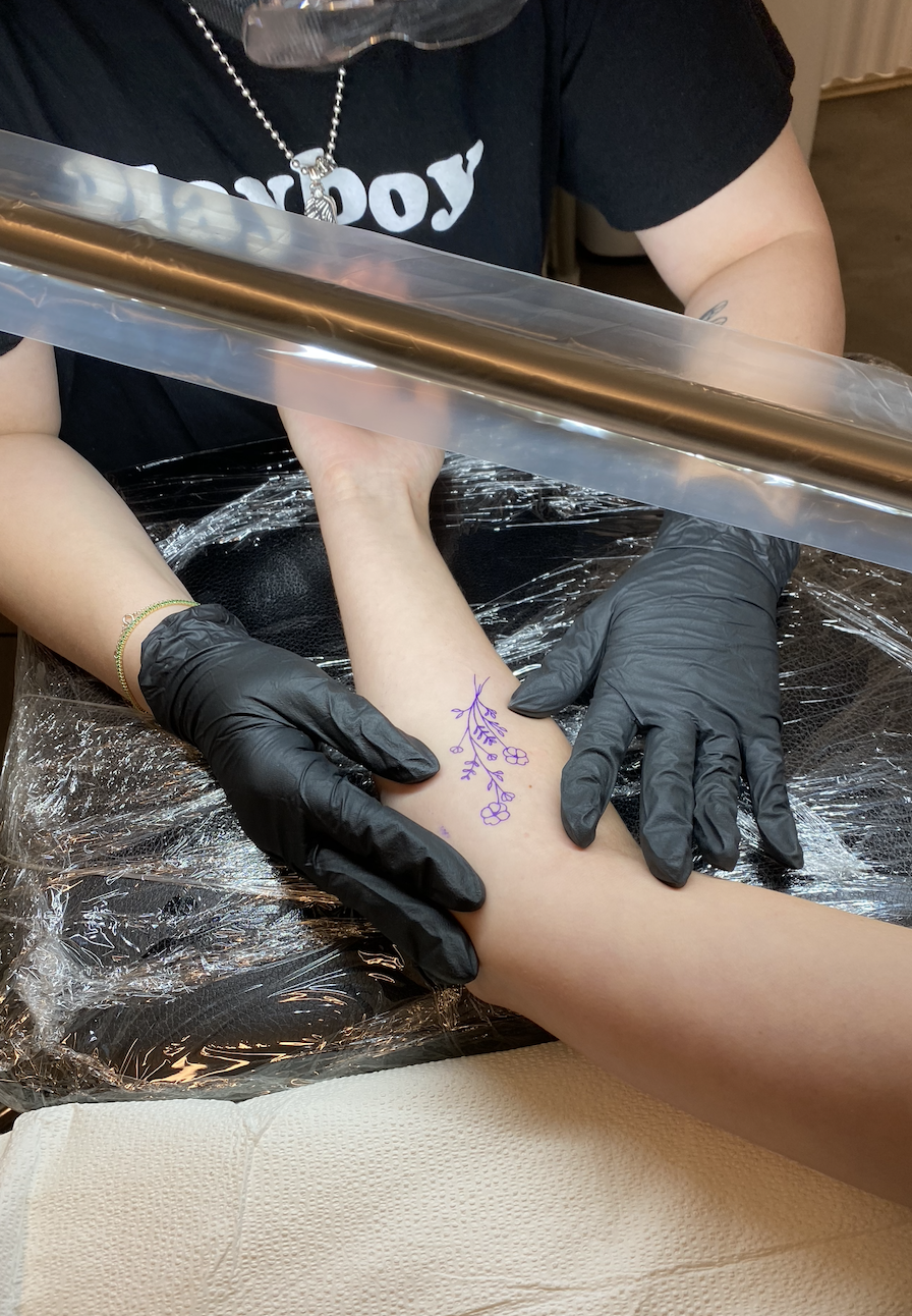 an arm being put on a table to tattoo
