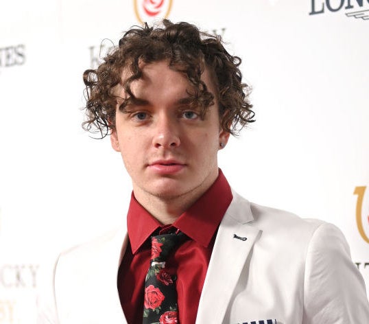 Jack wearing a suit with curly hair