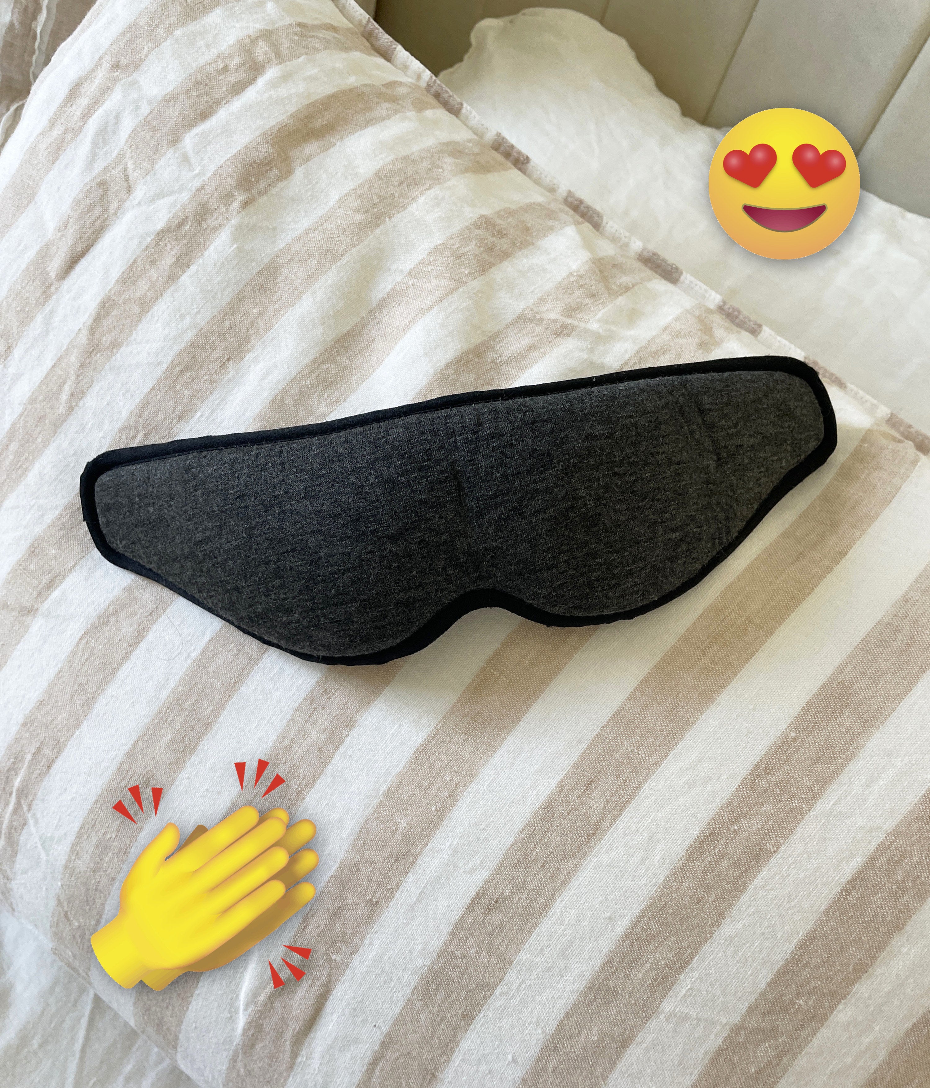 the eye mask laying on top of a pillow