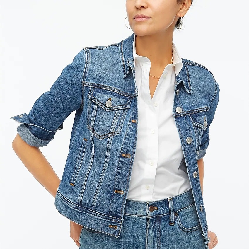 model wearing the denim jacket over a white button down with jeans