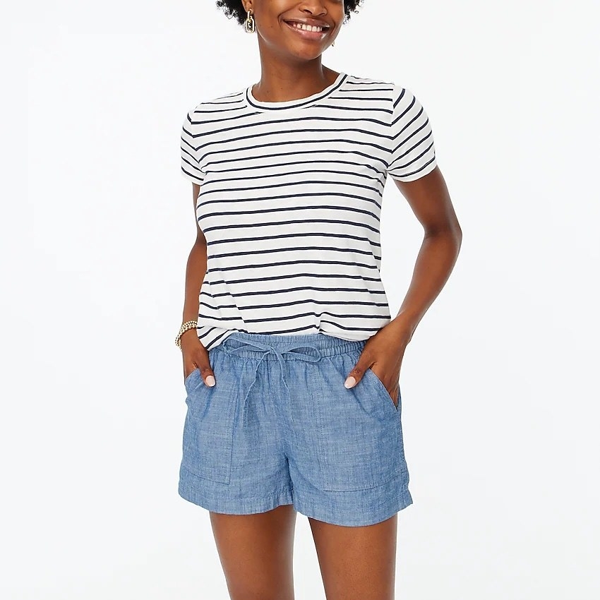 model wearing the chambray shorts with a black and white striped tee