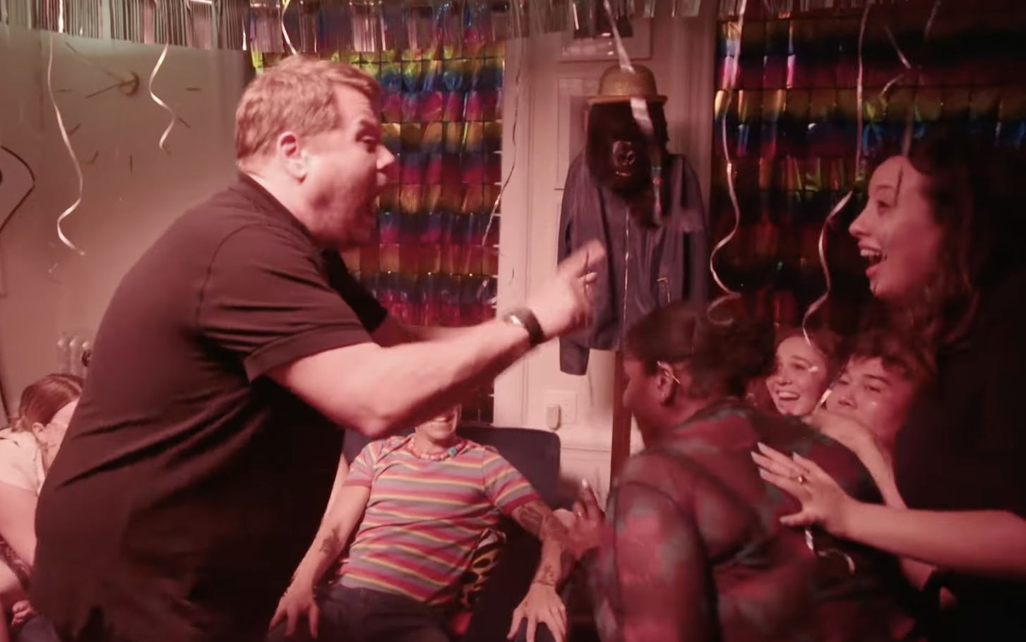 Corden screams at young women surrounded by party decorations