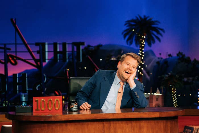 James Corden behind a desk on his talk show