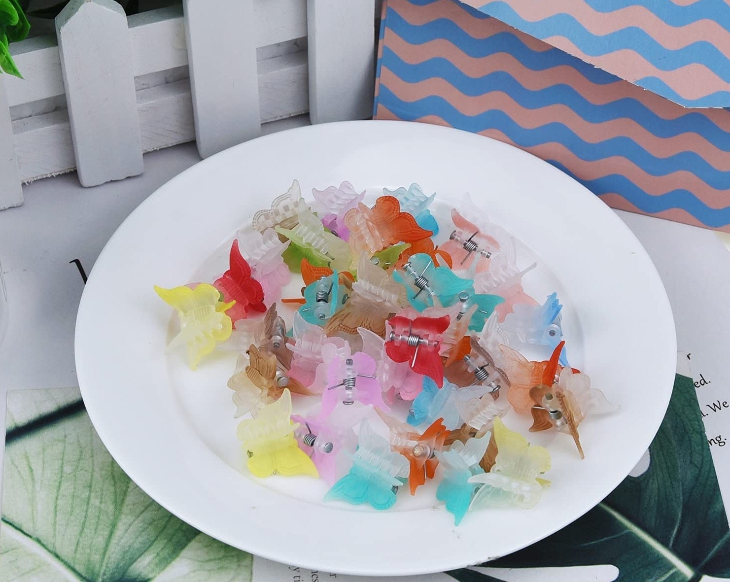 A bunch of the butterfly clips on a plate on a table