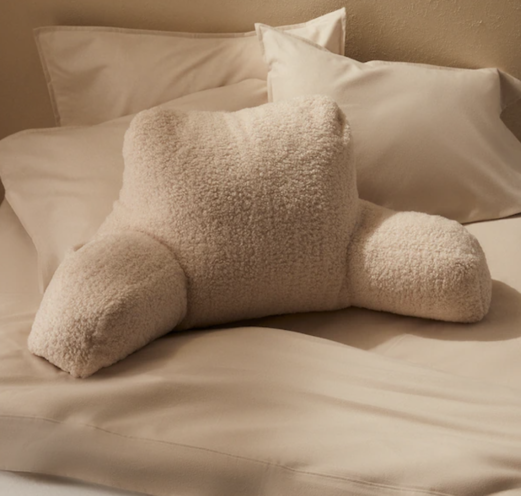 The plush backrest on a bed