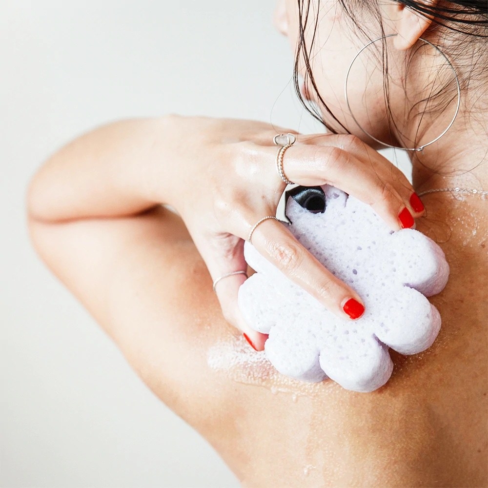 model using the lavender bath sponge in the shower