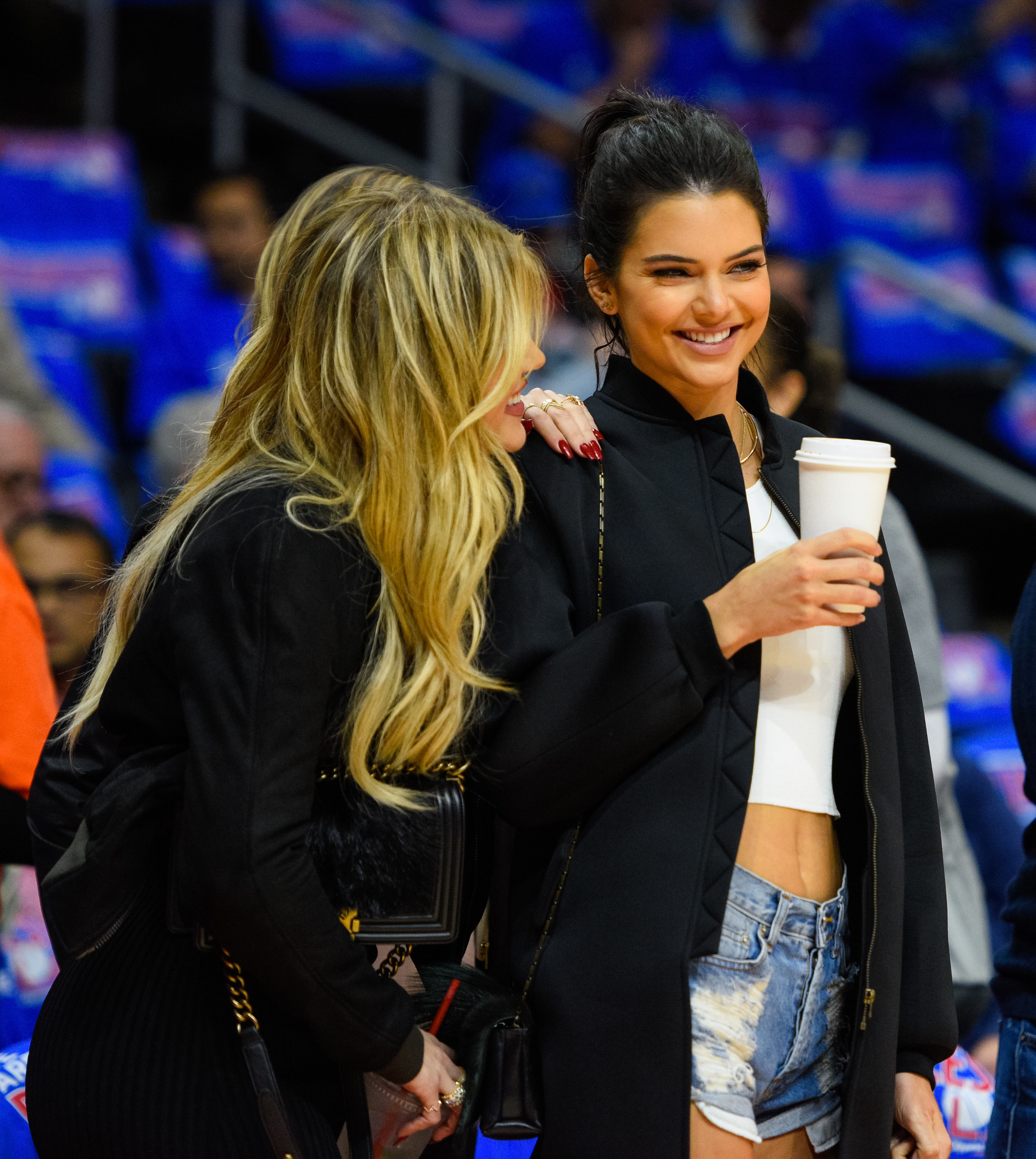 Khloé holds onto Kendall#x27;s shoulder and laughs with her