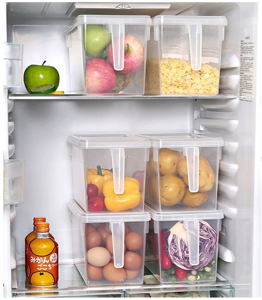A fridge with three bins full of food inside