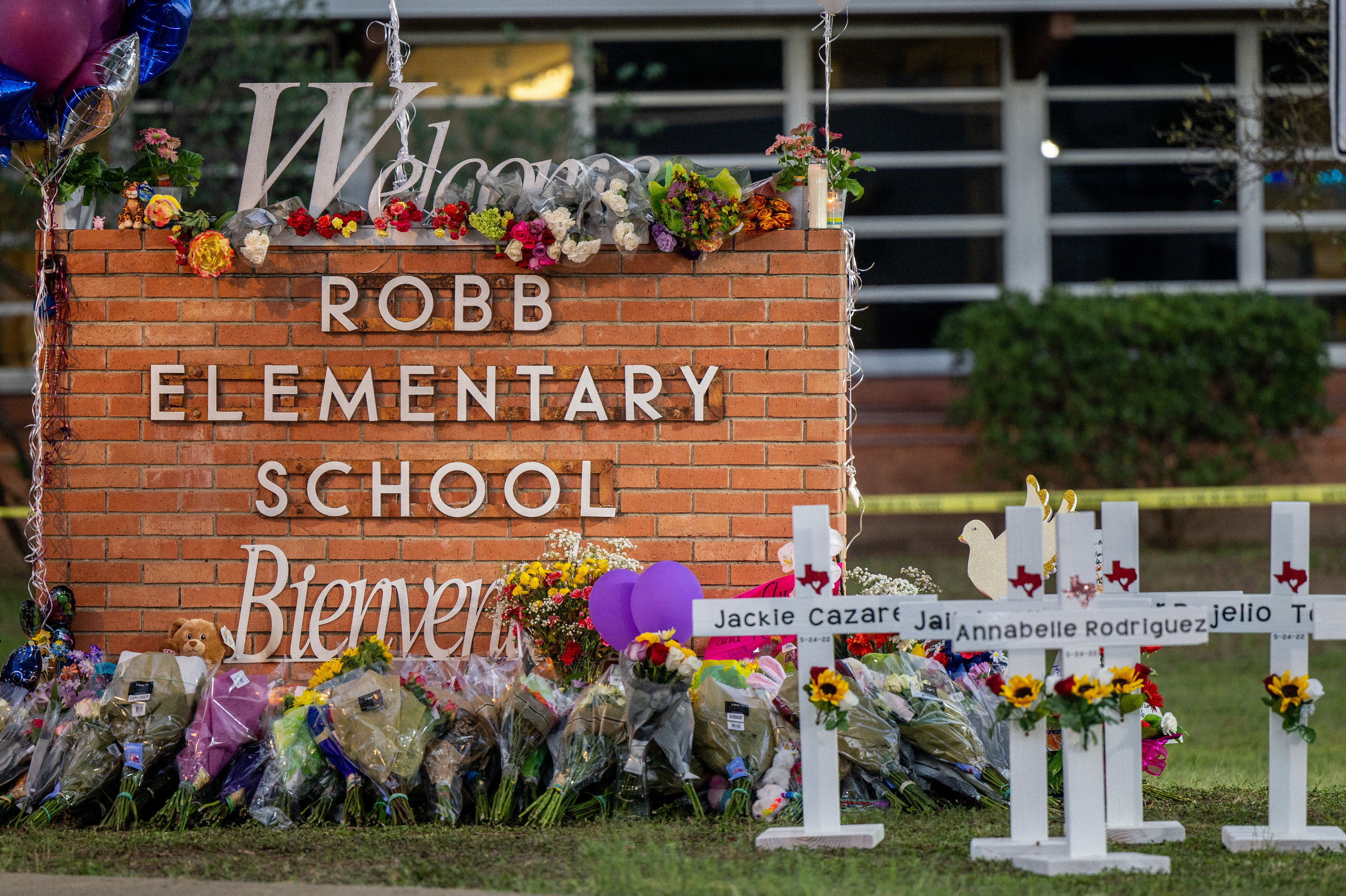 A memorial with flowers outside of Robb Elementary School in Uvalde, Texas