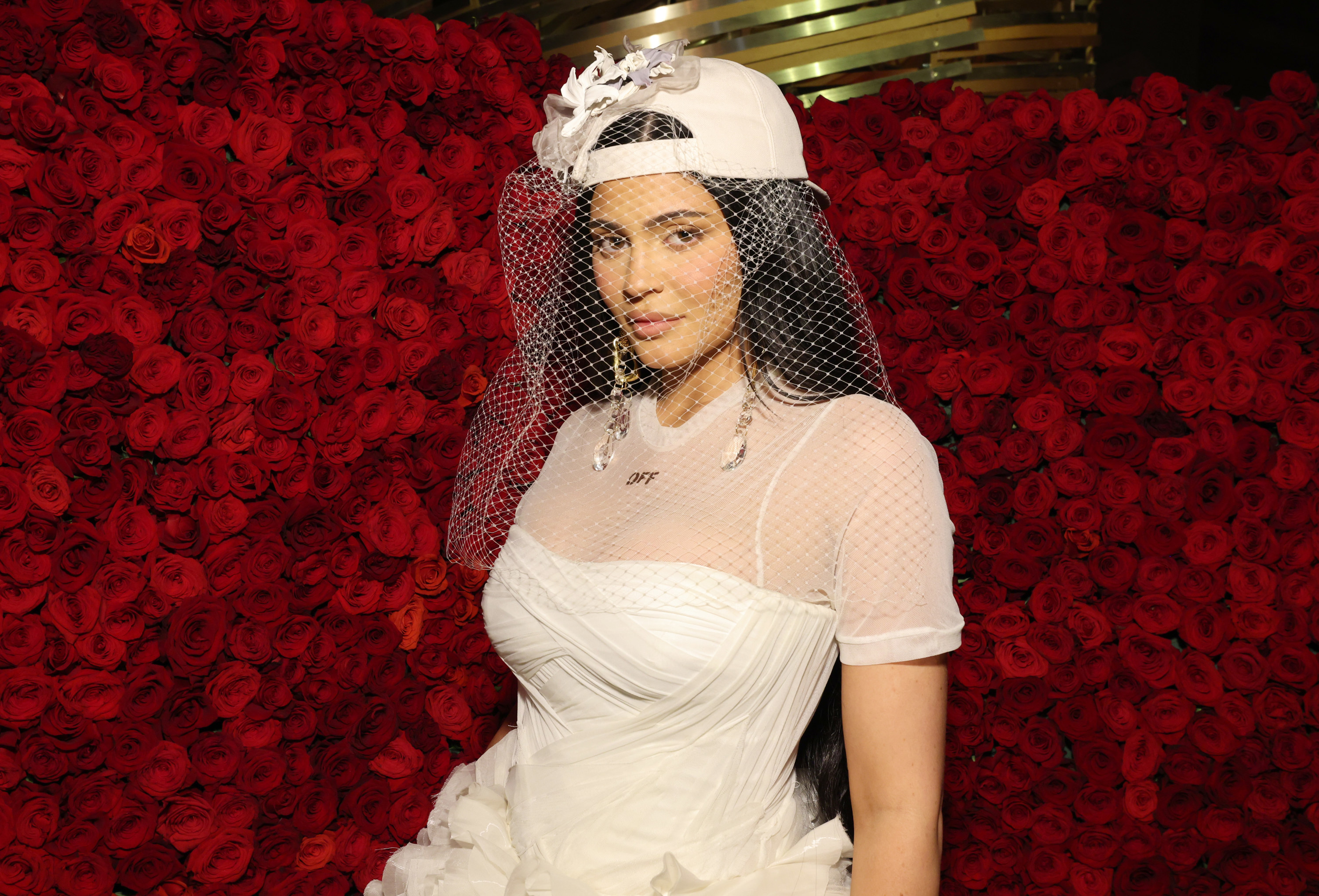 Jenner at the 2022 Met Gala in a white dress, baseball cap and wedding veil
