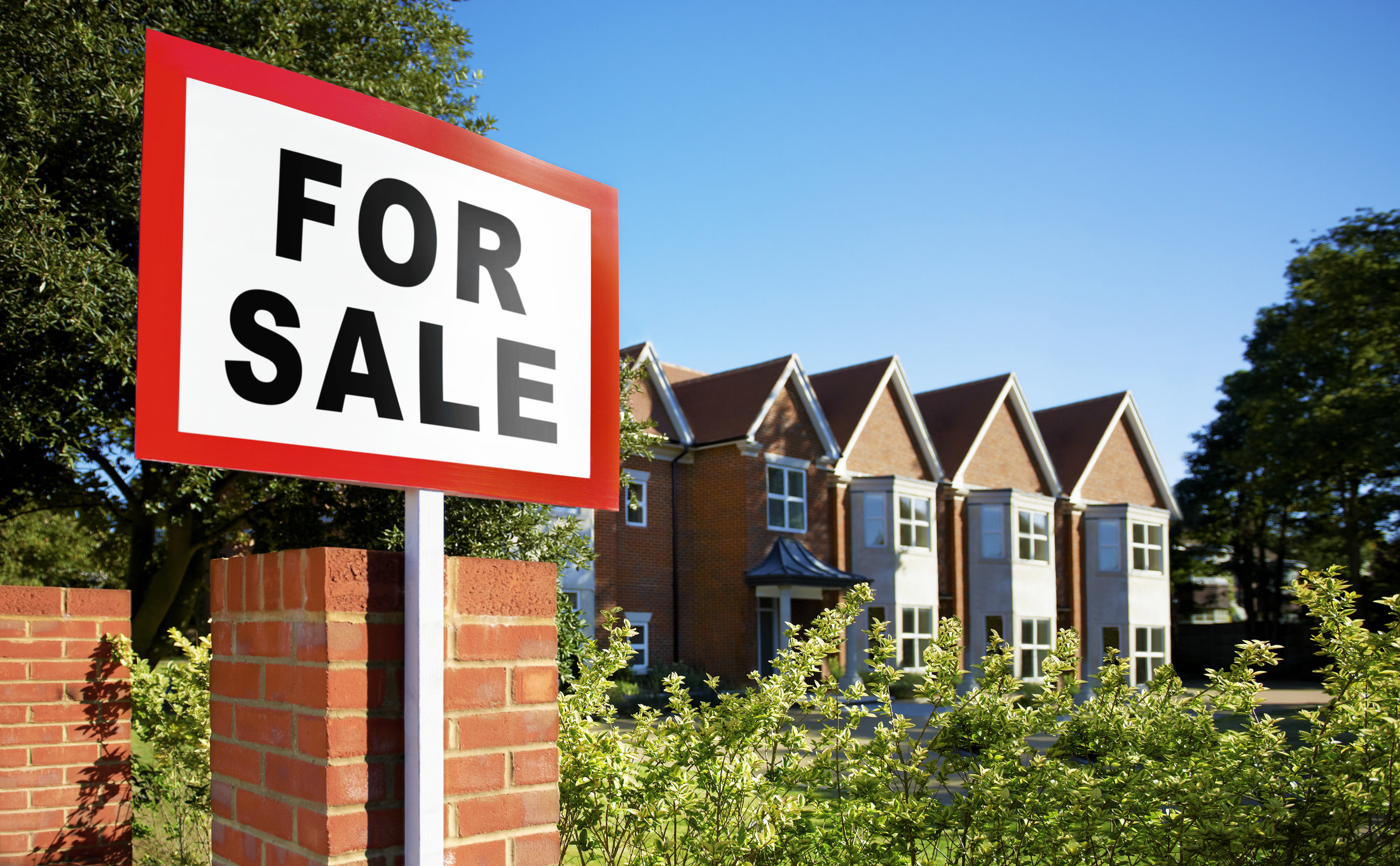 For sale sign in front of a house