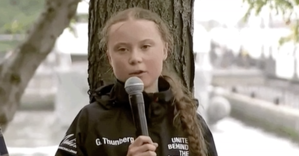 Greta Thunberg talking into a mic