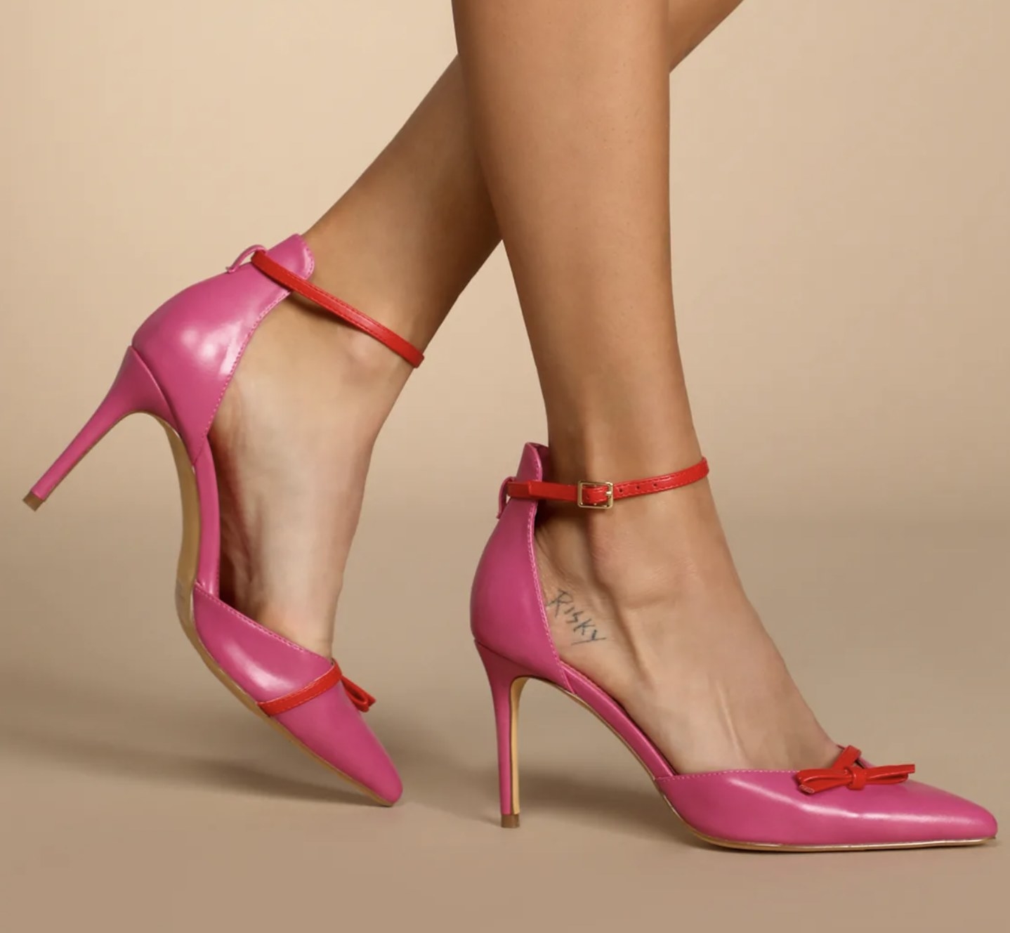 a model wearing the pumps in pink and red