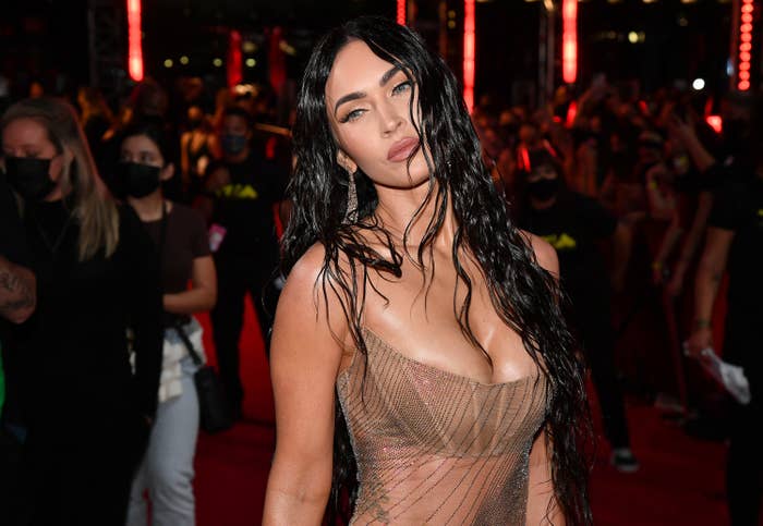 Megan at a red carpet event with wet-looking hair
