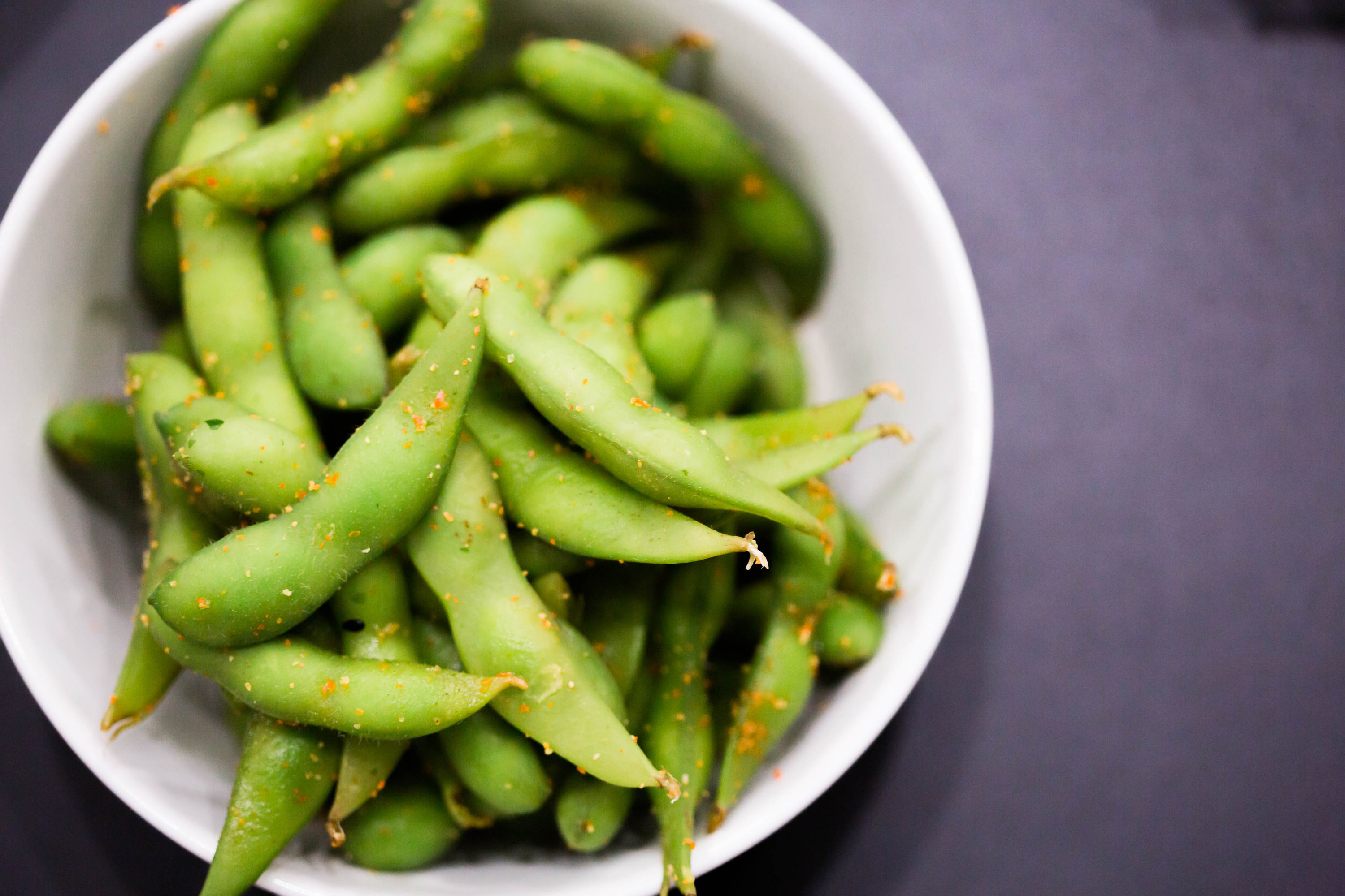 A bowl of containing edamame pods and seeds, which Megan compared her hair to