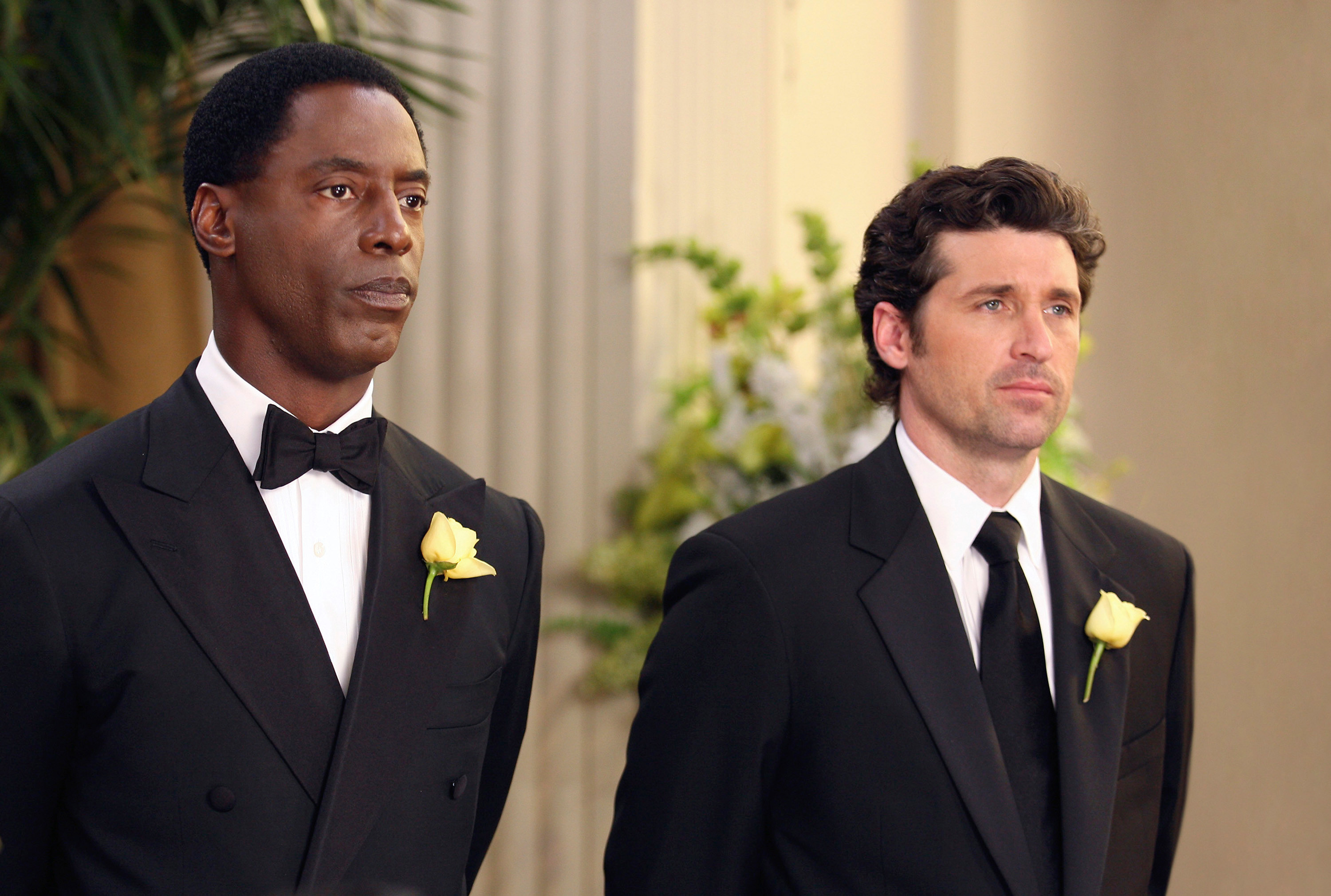 the two characters in suits at a wedding