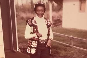 A photo of young Geneva Craig smiling in a 70's crocheted hat and matching vest.