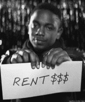 Kendrick Lamar tearing up a piece of paper that says &quot;rent&quot;