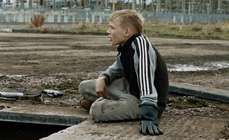 A boy is seen sitting by himself