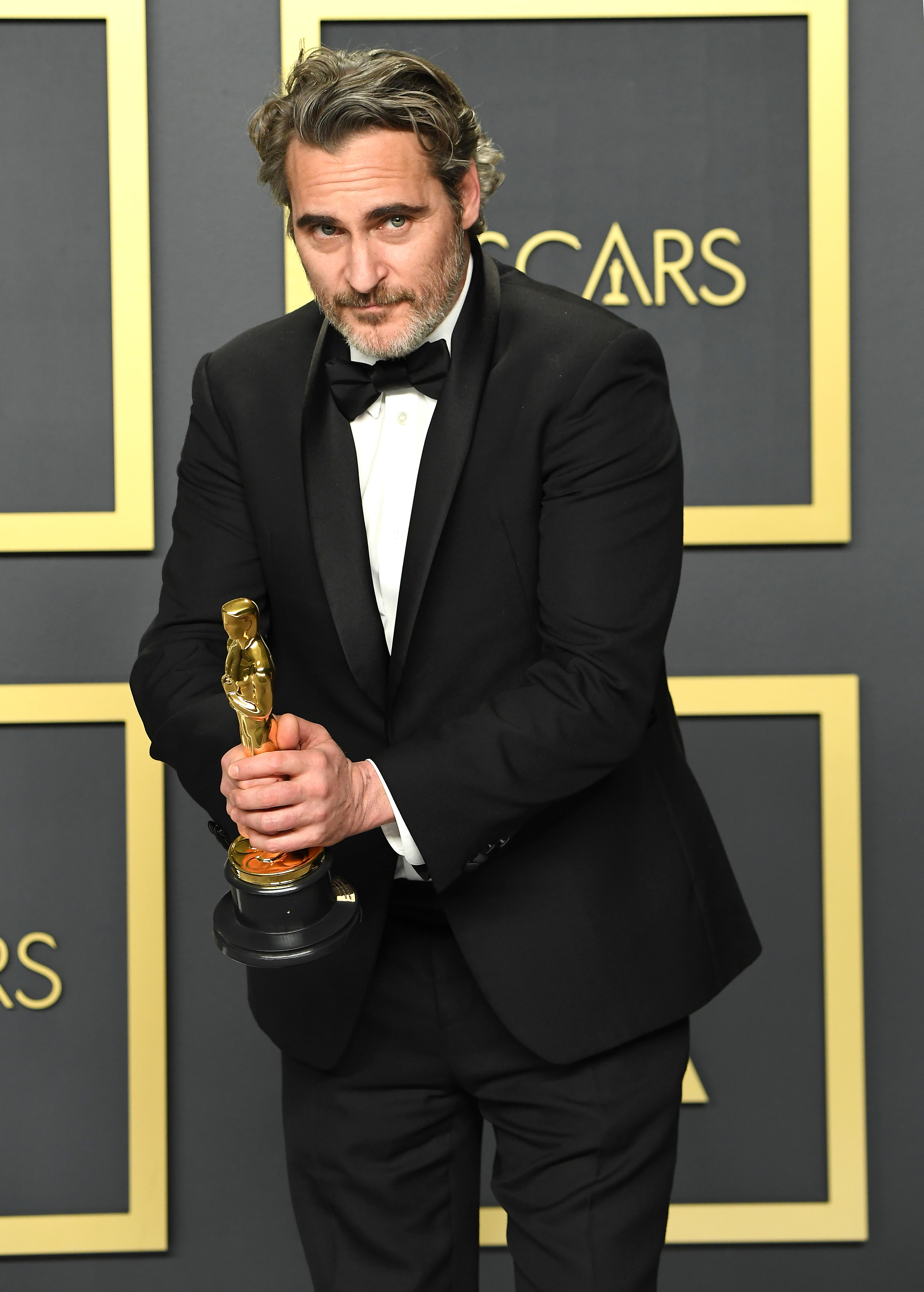 Joaquin Phoenix at 92nd Academy Awards in a suit