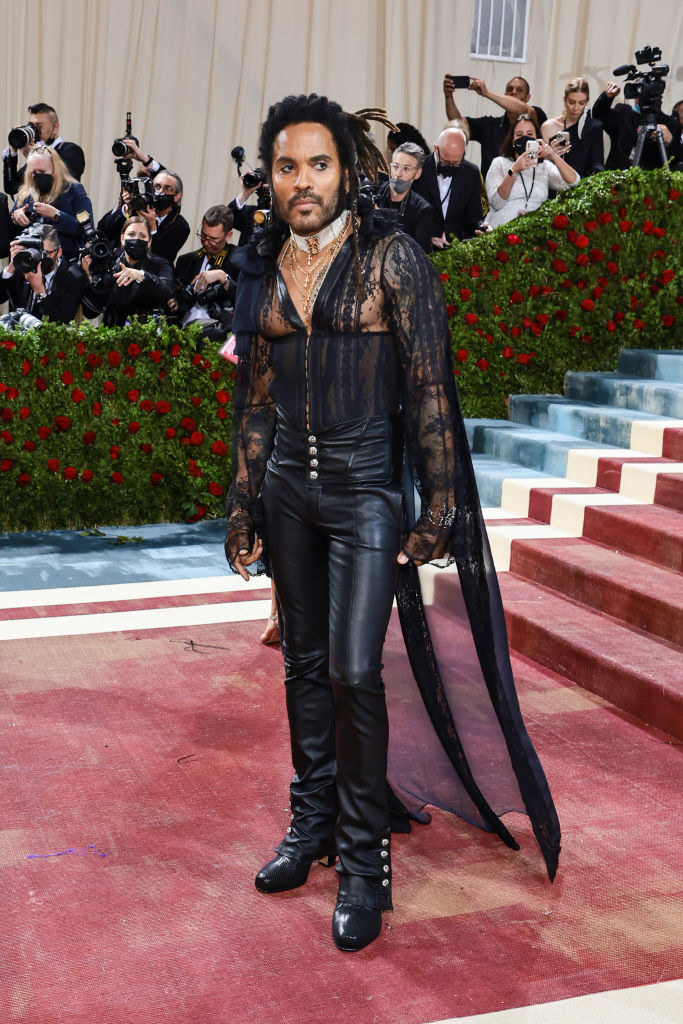 Lenny Kravitz wearing leather pants and top with a sheer train
