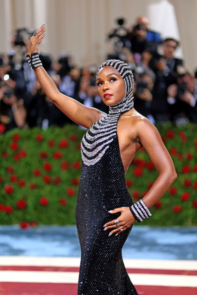 Janelle Monae raises her hand up