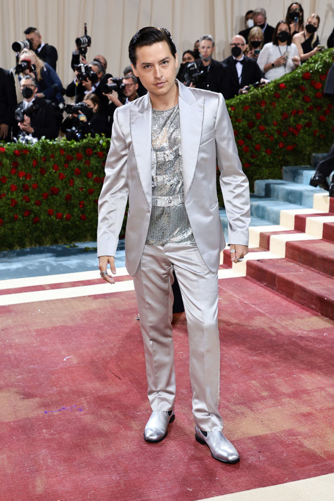 Cole Sprouse wearing a sparkly silver outfit