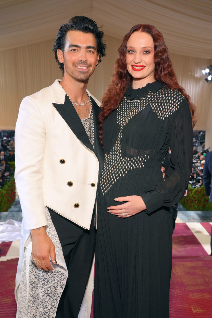 Joe Jonas standing with Sophie Turner, who&#x27;s holding her belly