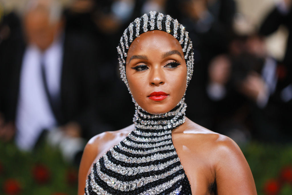 A closeup of Janelle Monae wearing the headpiece and gown